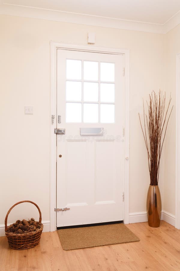 Hallway and front door. Contemporary hallway in a house with a white front door royalty free stock photos